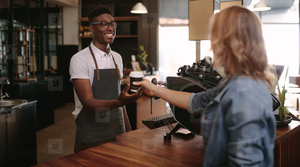 Independent coffee shop owner serving a regular customer